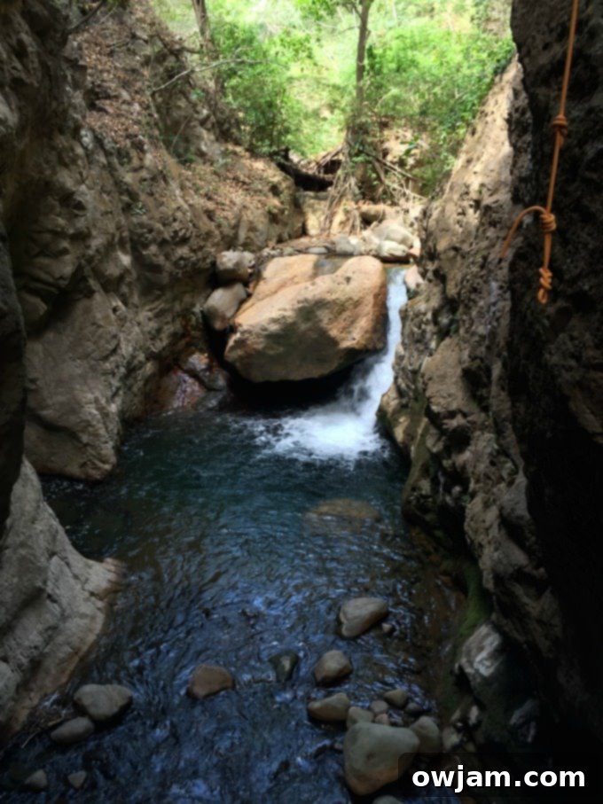 Rappelling down a waterfall during ziplining excursion