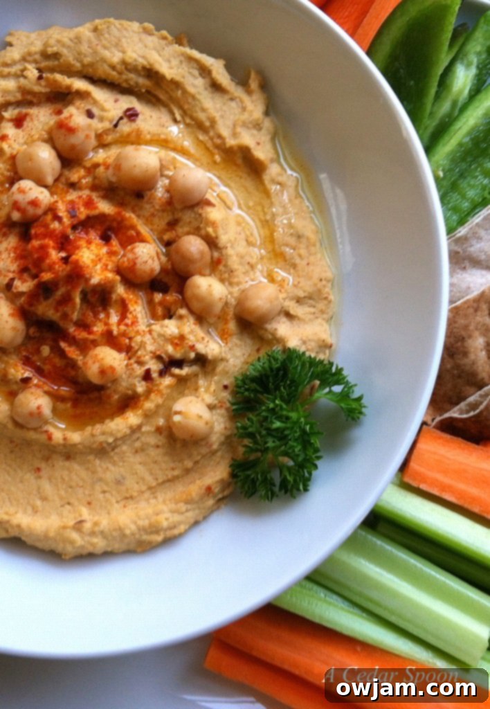 Spicy hummus topped with chili flakes and a swirl of olive oil, ready to serve