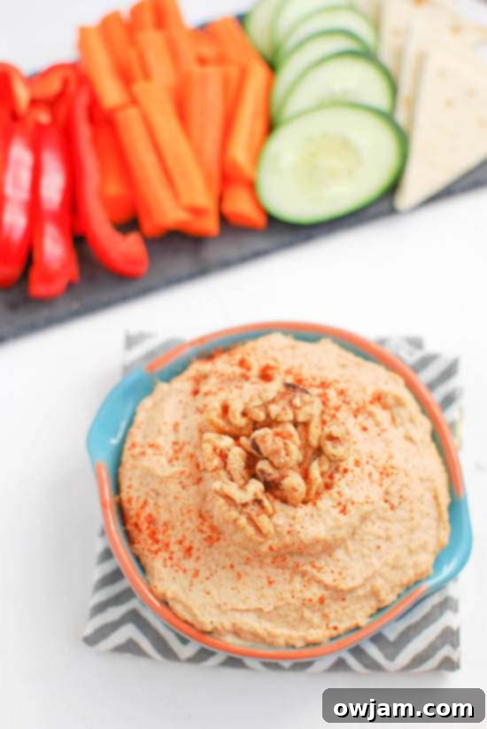 Spicy Roasted Garlic and Walnut Hummus, garnished with chopped walnuts and chili