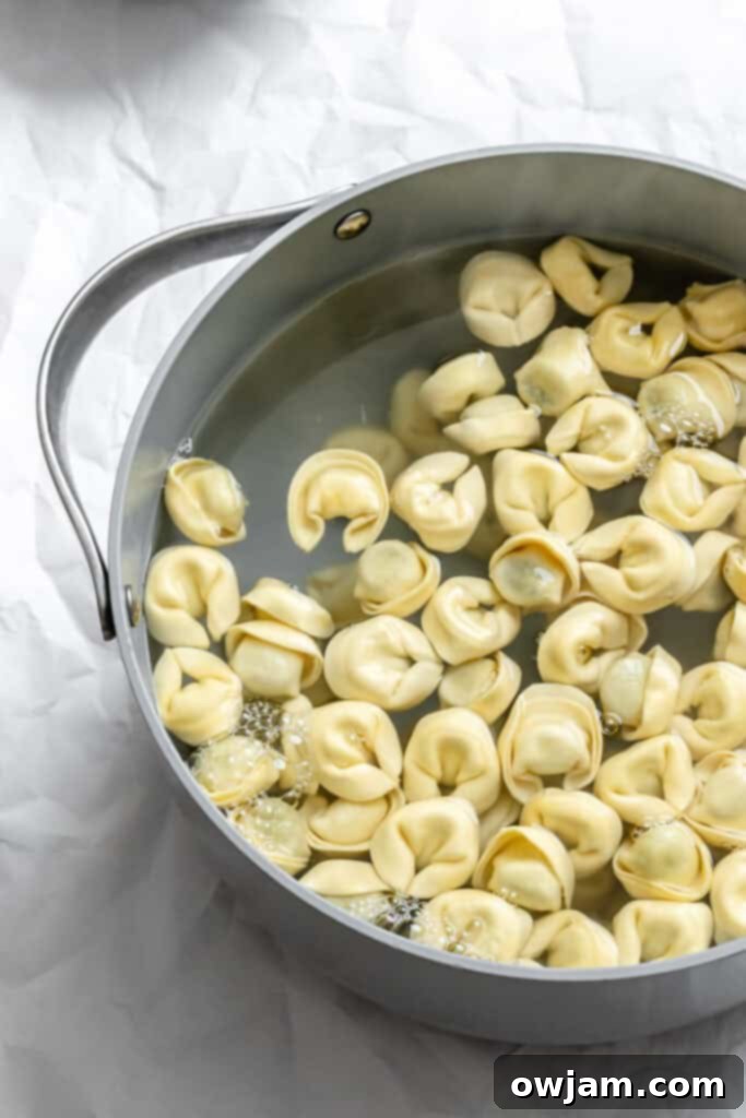 Speedy Cheesy Pesto Tortellini Dinner 4 tortellini boiling in water