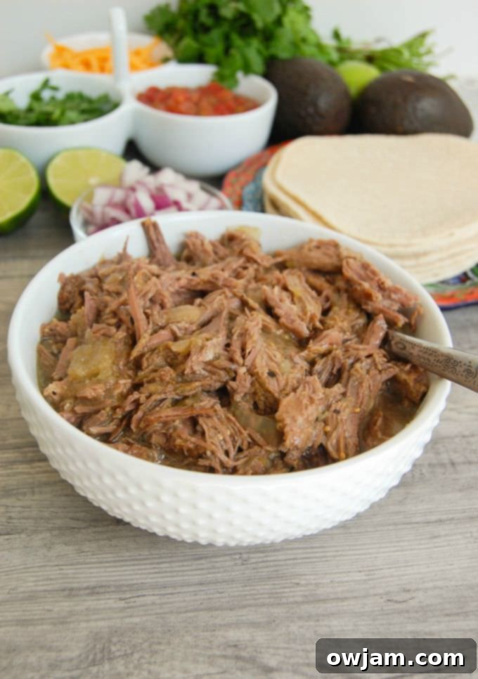Flavorful Slow Cooker Shredded Beef Tacos 5 A bowl of Slow Cooker Shredded Beef Tacos, showcasing the tender beef and vibrant toppings.