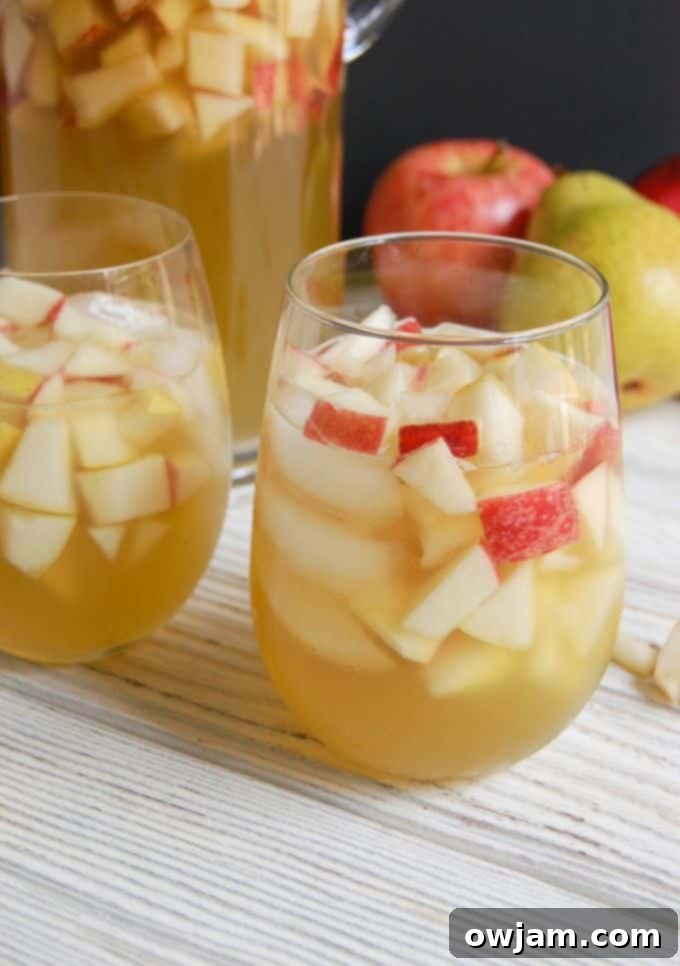 Orchard Sparkle Sangria 4 Sparkling Apple Pear Sangria in a pitcher with apples and pears