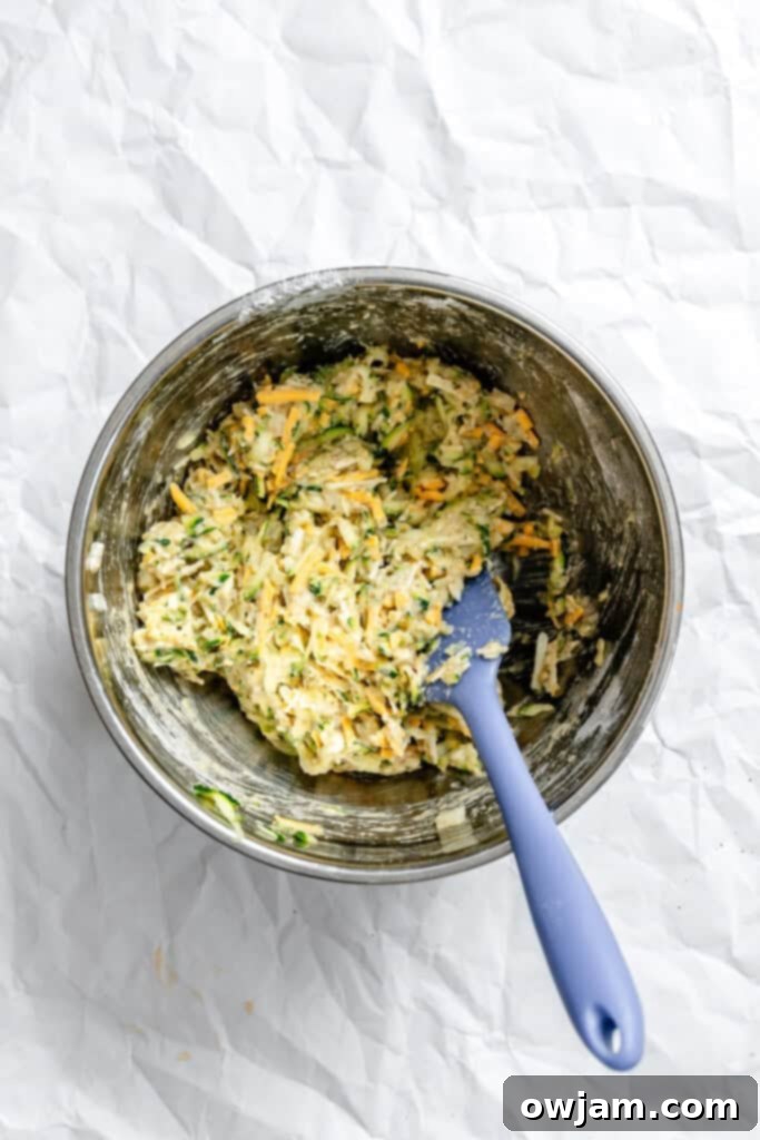 Effortless Zucchini Fritters 7 Zucchini fritter batter mixed in a bowl, ready for cooking.