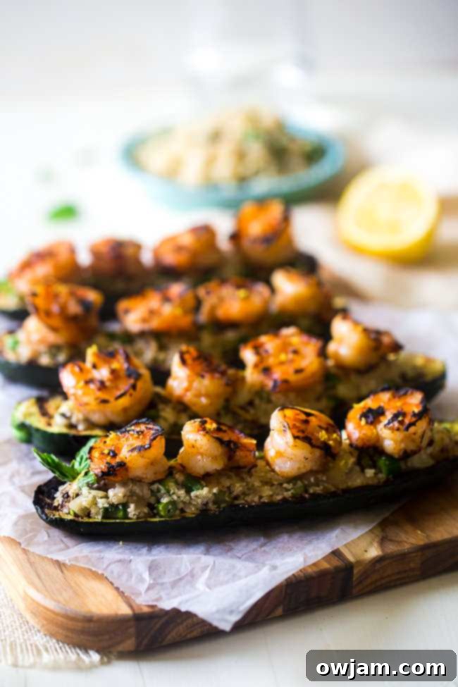 12 Mouthwatering Zucchini Recipes 8 Grilled zucchini halves stuffed with cauliflower rice and shrimp, a healthy and flavorful meal.