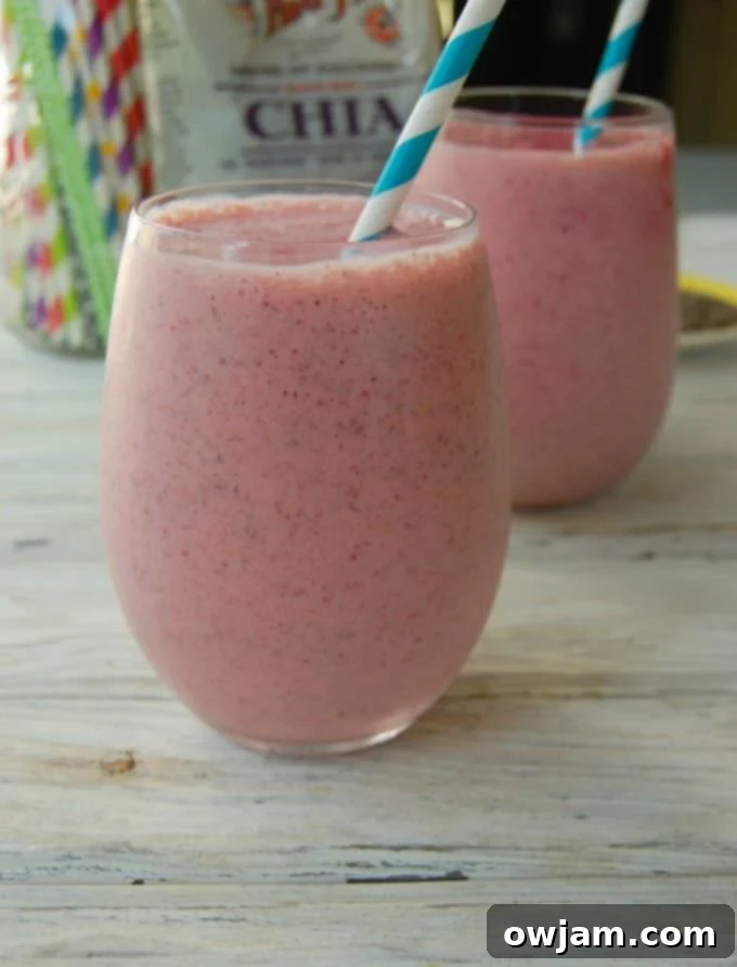 Strawberry Banana Chia Delight 2 Vibrant Strawberry Banana Chia Smoothie in a tall glass, garnished with fresh strawberries, ready to be enjoyed.