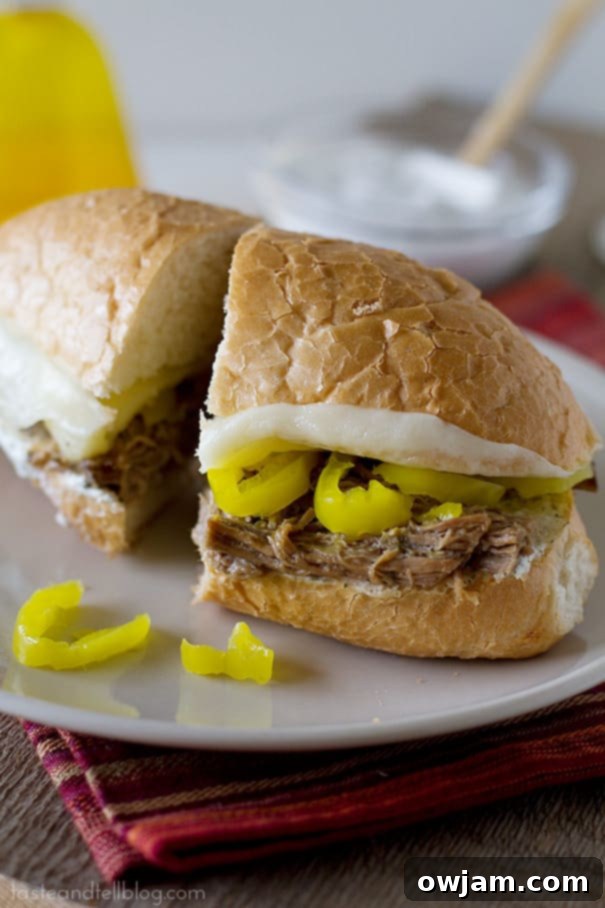 Slow Cooker Italian Beef Sandwiches with colorful bell peppers and onions.