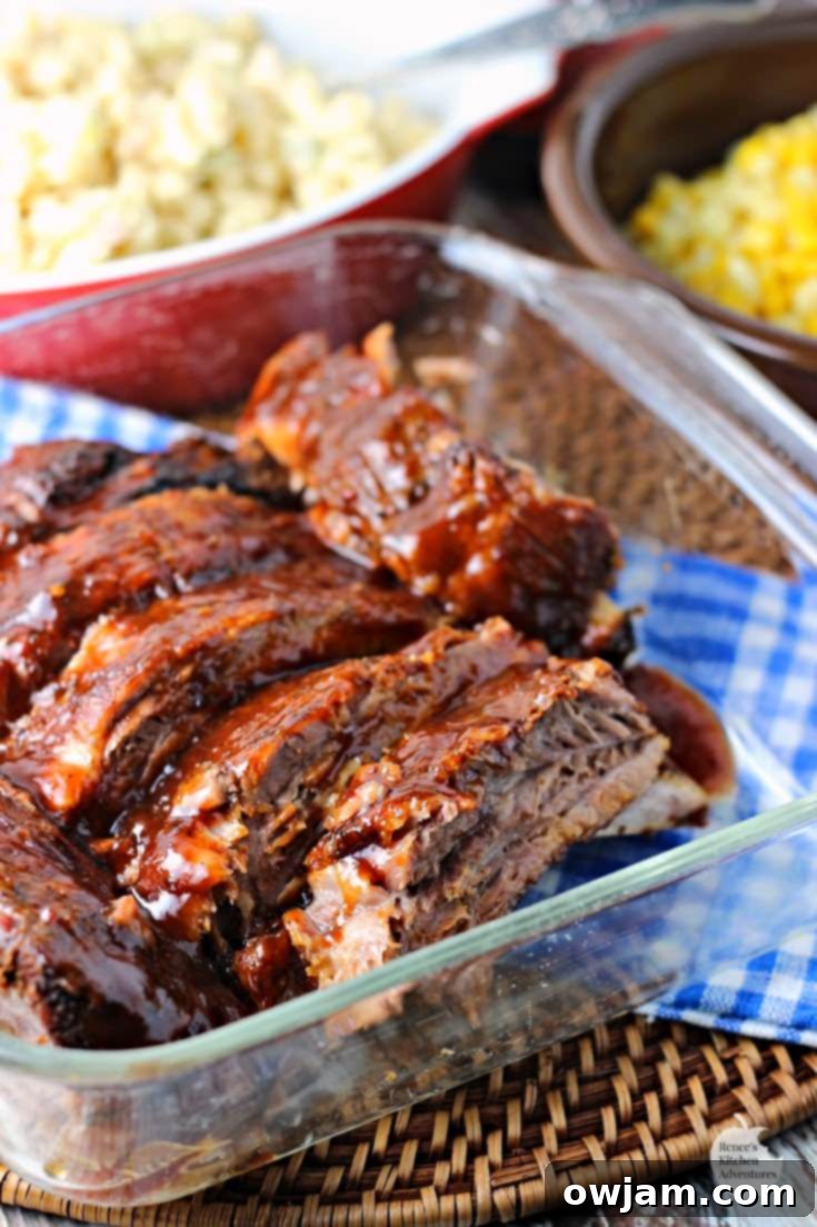 Platter of perfectly cooked fall-off-the-bone slow cooker ribs, glazed with BBQ sauce.