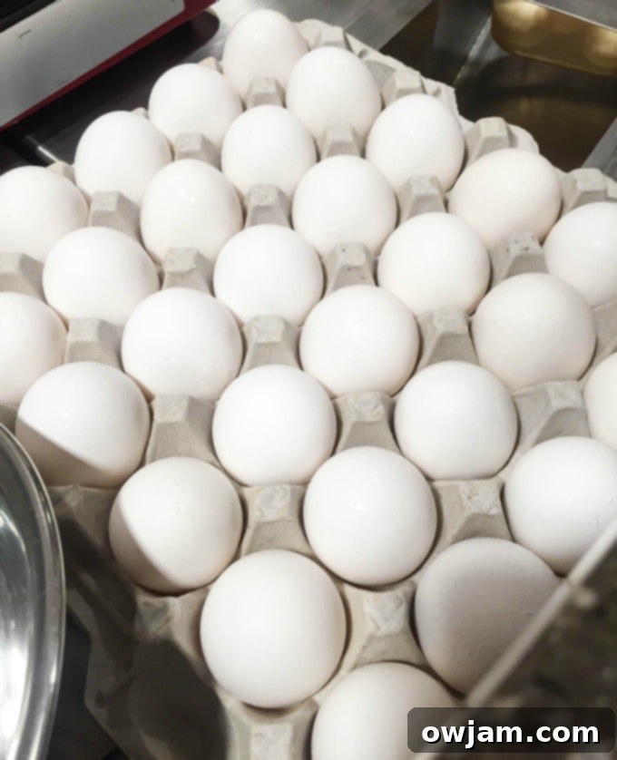 A close-up shot of raw eggs in a bowl, ready for whisking for the egg muffin recipe.