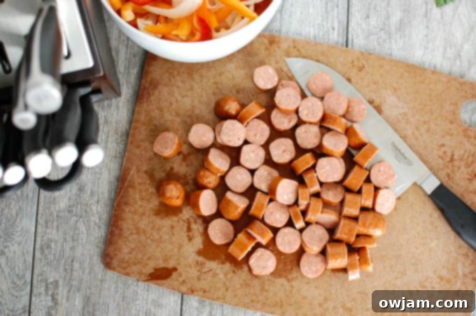 Sautéing sausage and vegetables in a large pot for One Pot Cajun Pasta.