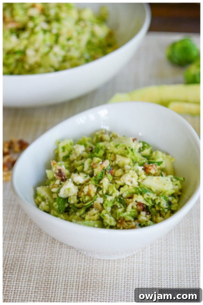 Refreshing Brussels Sprouts and Apple Salad with crumbles of blue cheese, offering a delightful mix of sweet, tangy, and savory flavors