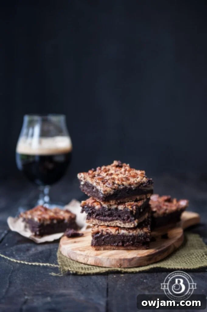 Rich Pecan Pie Smoked Porter Brownies, featuring a gooey pecan topping on a dark brownie base.
