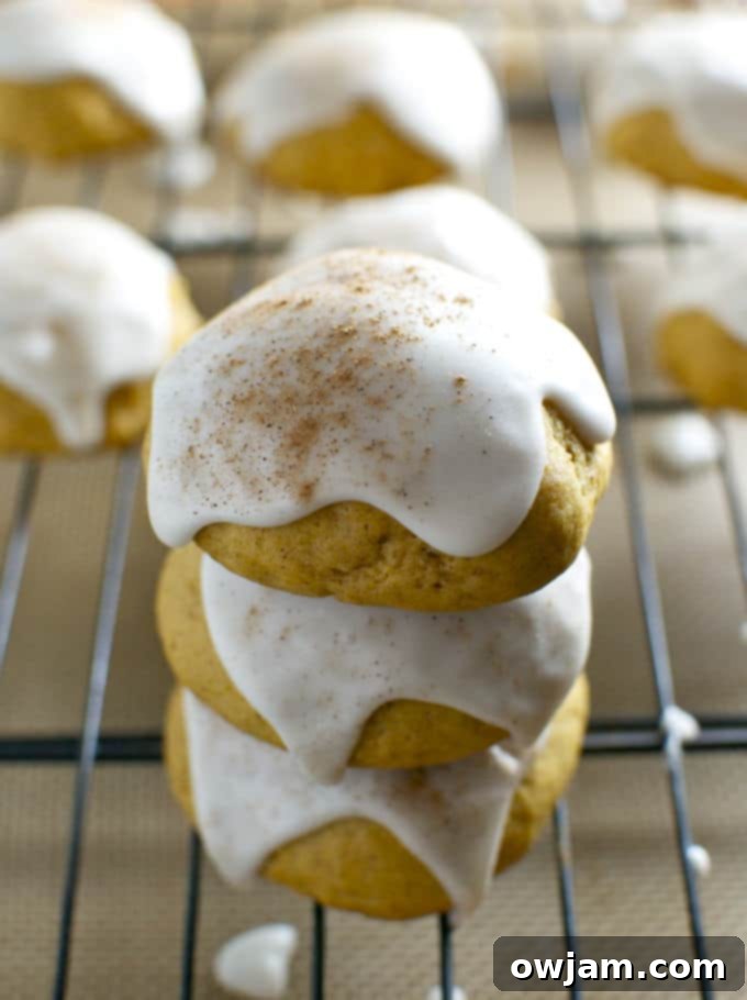 Platter of soft pumpkin cookies drizzled with a sweet maple glaze, a perfect fall treat.
