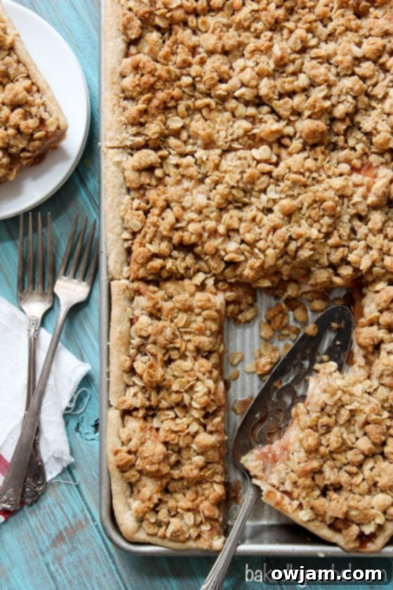 Large Apple Crumb Slab Pie, featuring a golden crumb topping and visible apple filling, baked in a rectangular pan.