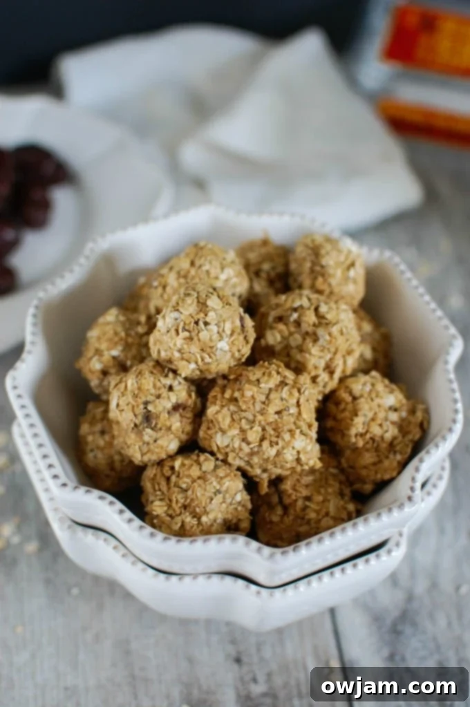 No-Bake Peanut Butter Oat Energy Bites 2 Delicious Peanut Butter Oatmeal No Bake Bites stacked up on a wooden surface, ready for a healthy snack break.