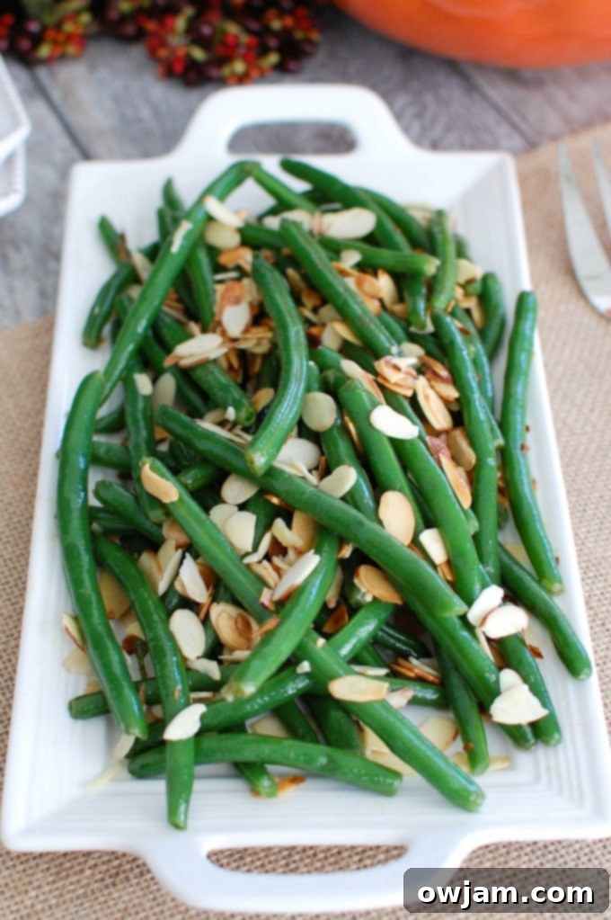 Brown Butter Almond Green Beans 3 Close-up of Green Beans with Brown Butter and Toasted Almonds, showing the glossy coating and crunchy almonds