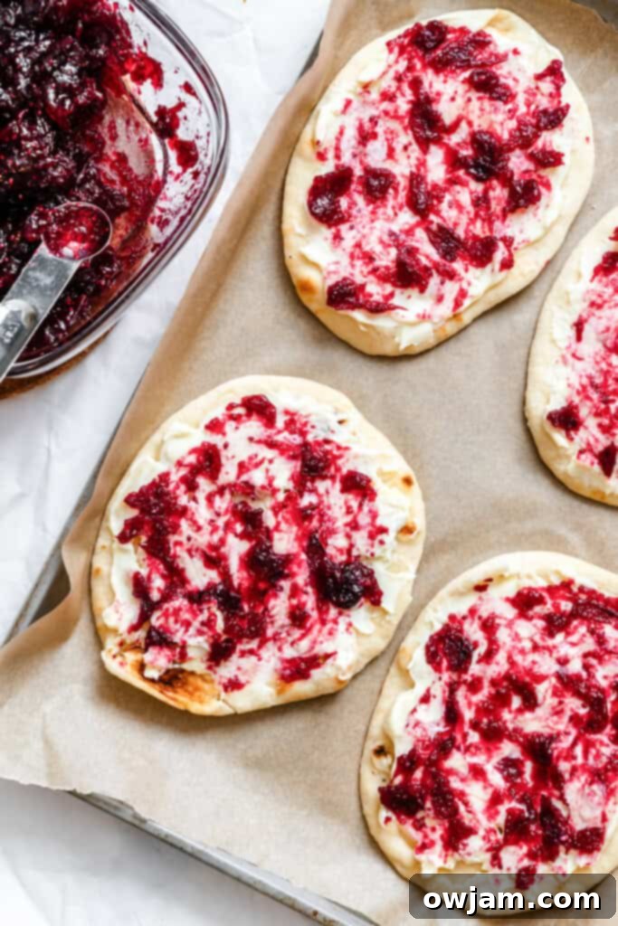 Warm Brie Cranberry Naan Bread with sauce on naan