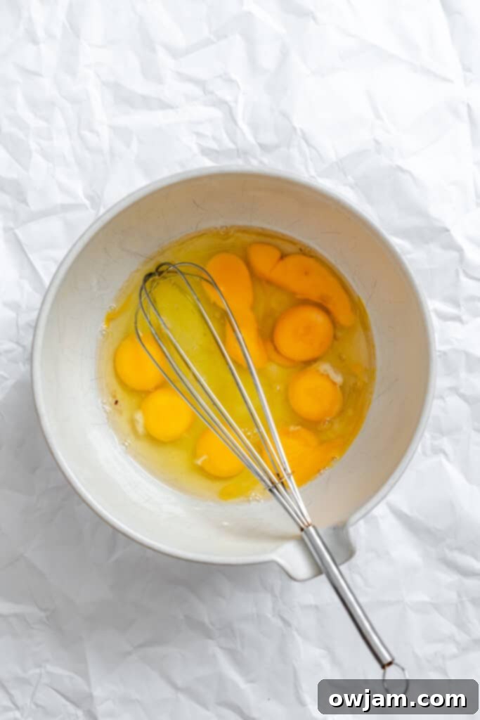 Cheesy Black Bean Egg Bake eggs being whisked in a bowl