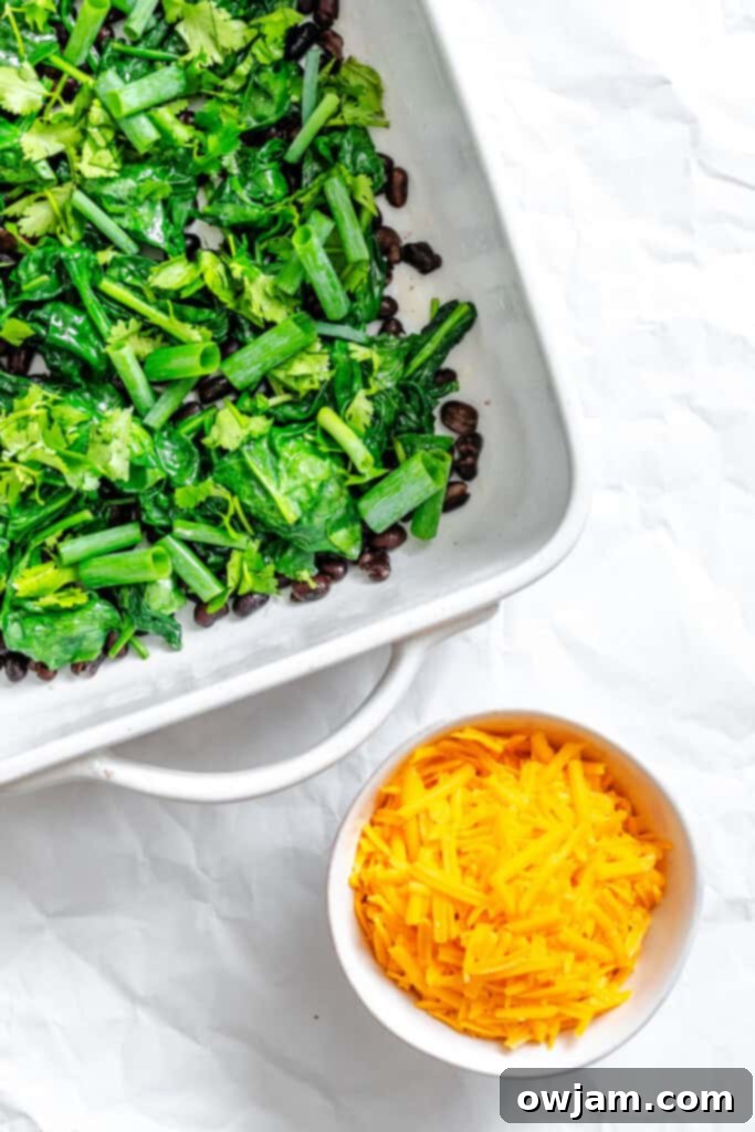 Cheesy Black Bean Egg Bake black beans layered in a baking dish