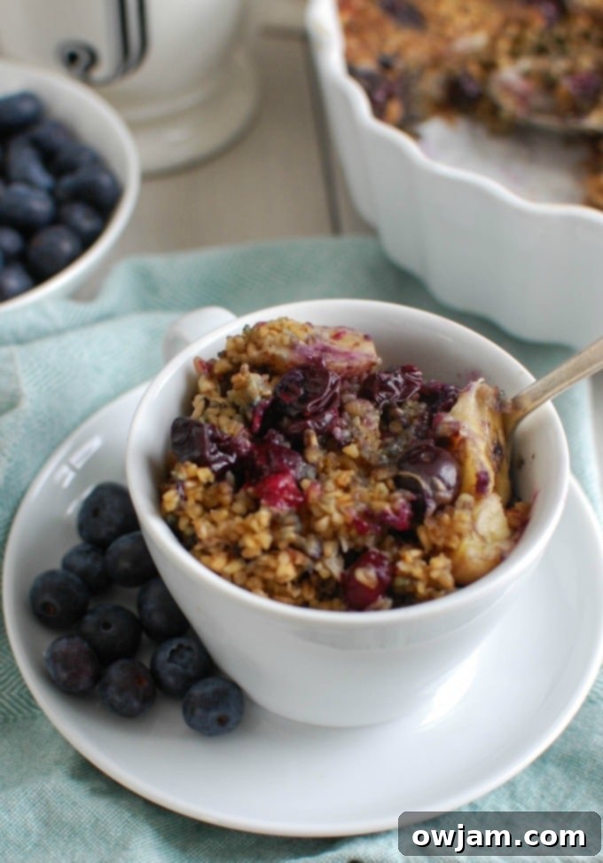Close-up of baked blueberry banana steel cut oatmeal in a serving dish, showing the delicious texture and fruit