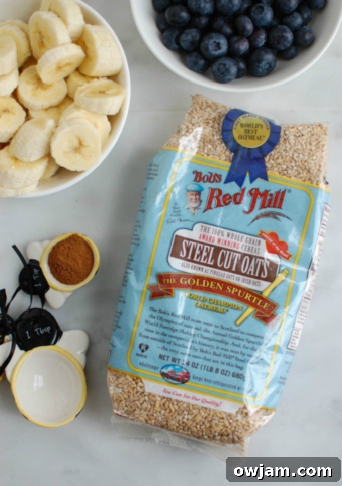 Ingredients for Baked Blueberry Banana Steel Cut Oatmeal laid out, including steel cut oats, fresh blueberries, and bananas
