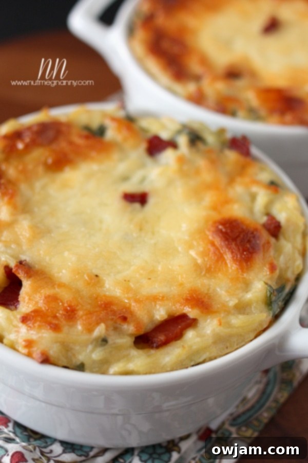 A rustic bowl filled with orzo pasta, crispy bacon, tender collard greens, all coated in a luscious cauliflower cheese sauce.