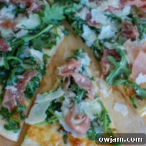 Peppery Arugula Prosciutto Pie 7 Close-up of a Prosciutto Arugula Pizza slice.