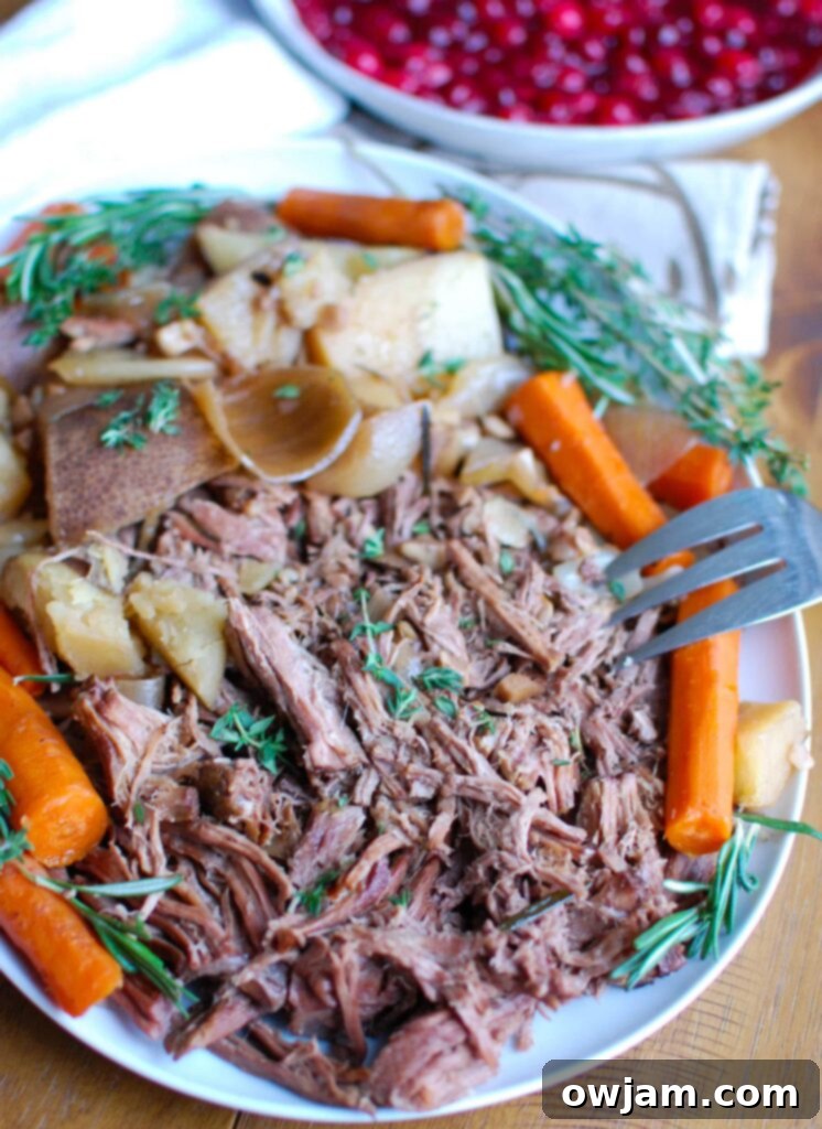 Slow Cooker Red Wine Pot Roast With Orange Cranberry Sauce is the perfect winter comfort food. This pot roast is flavorful and would make a nice holiday meal. The orange cranberry sauce adds a nice touch of sweetness to the roast and a pop of color to your tab