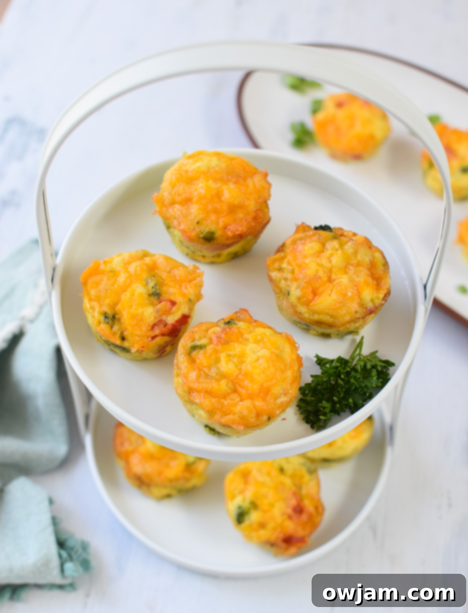 A single Broccoli Cheddar Cup served on a small white plate, ready to be enjoyed.