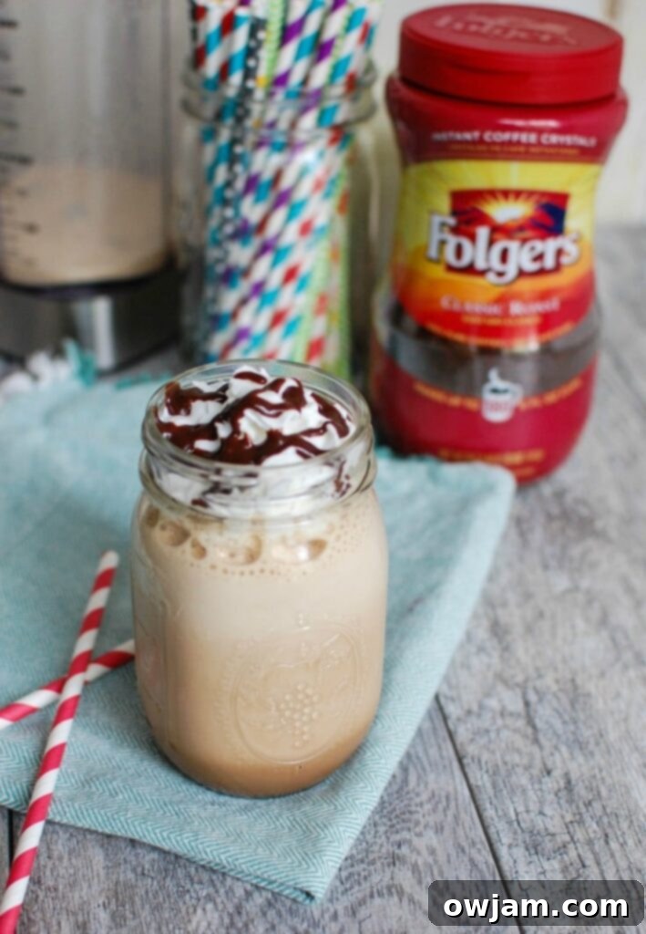 Ingredients for Homemade Mocha Frappuccino laid out, including instant coffee, milk, sugar, and chocolate sauce.