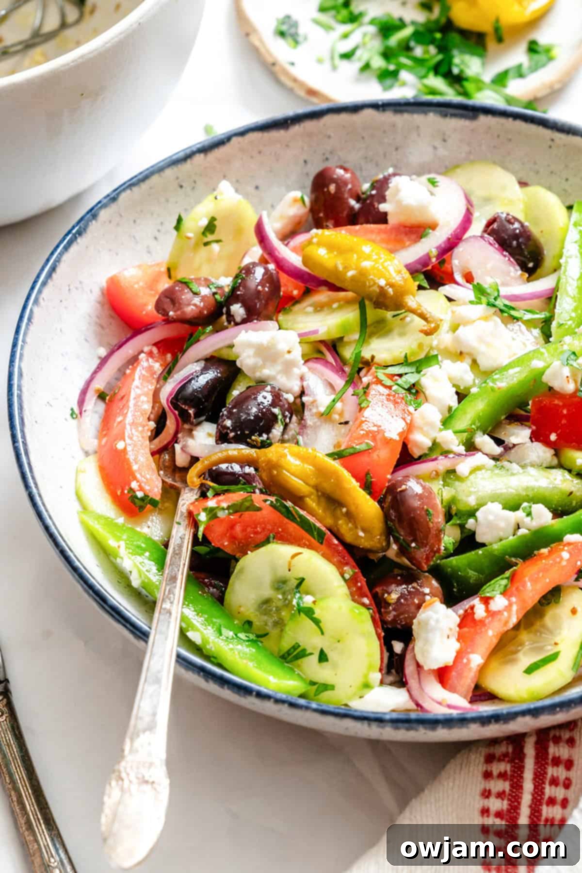 Rustic Greek Salad 2 Fresh Greek Village Salad in a white bowl with a fork, ready to be enjoyed