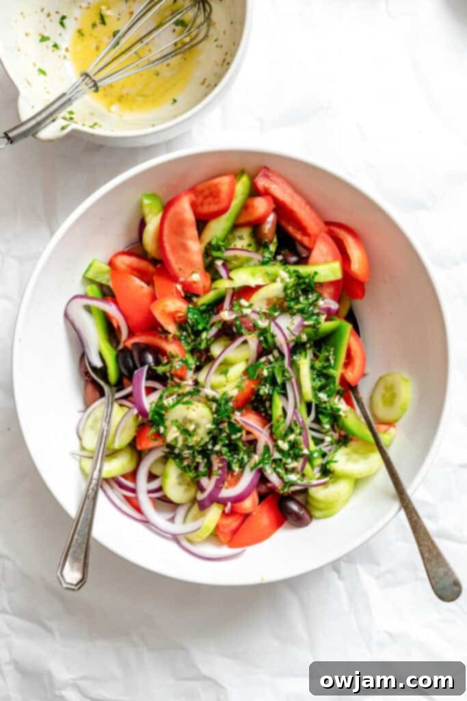 Rustic Greek Salad 9 Greek Village Salad vegetables in a bowl with herbs, ready for dressing