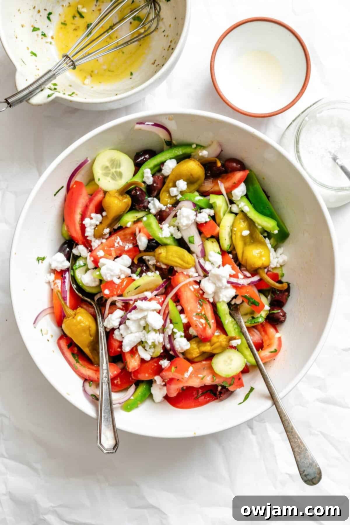 Rustic Greek Salad 10 Greek Village Salad in a bowl with serving spoons, ready for a family meal