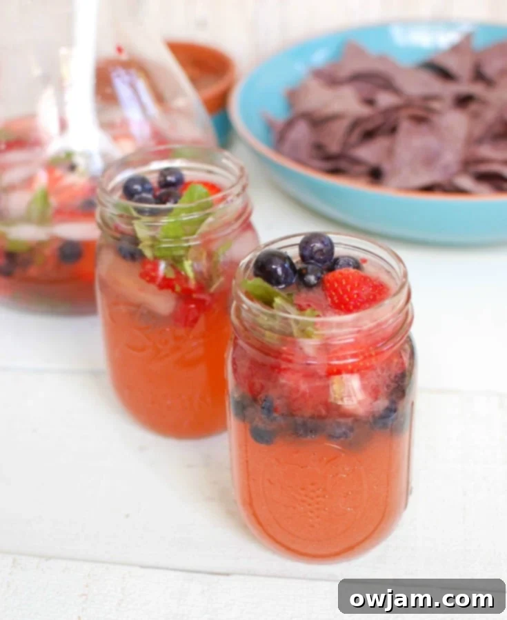 Strawberry Blueberry Lemonade Sparkler 4 Delicious Strawberry Blueberry Lemonade Spritzer in a pitcher and glass, ready to be enjoyed