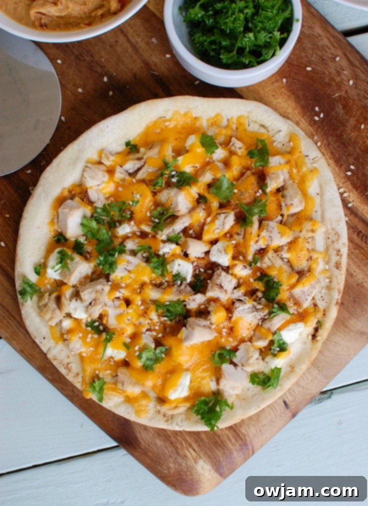 Chicken Feta Cheddar Pita Pizzazz 4 Finished Chicken Feta Cheddar Pita Pitza, fresh out of the oven, sprinkled with cheese and parsley.