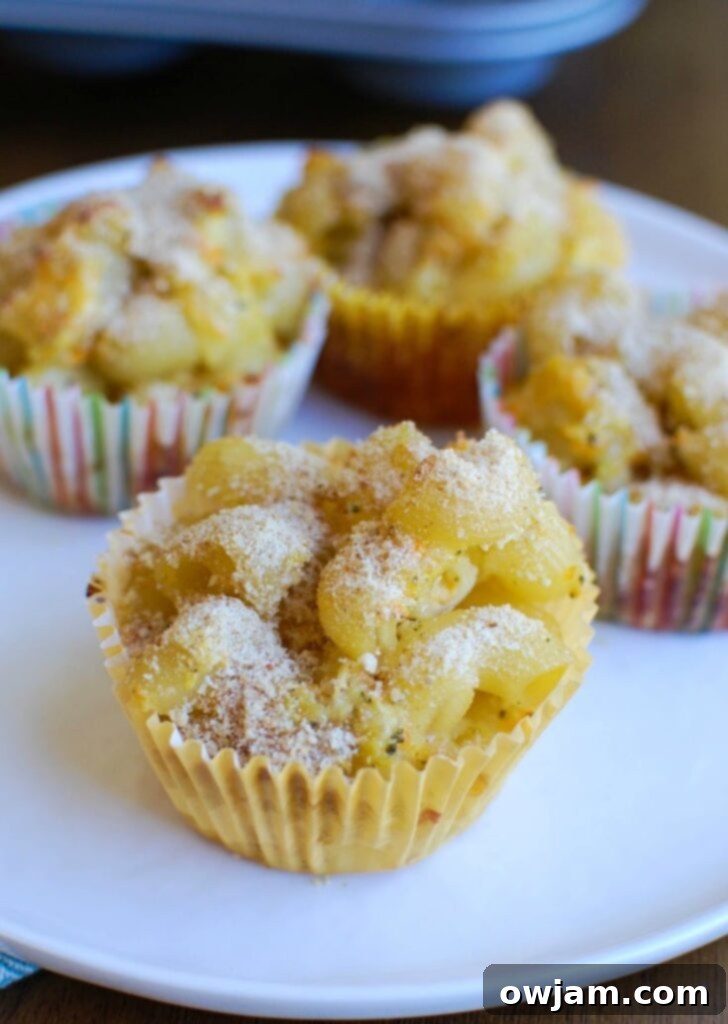 Unbaked Mac and Cheese Muffins mixture in a muffin tin, ready for the oven.
