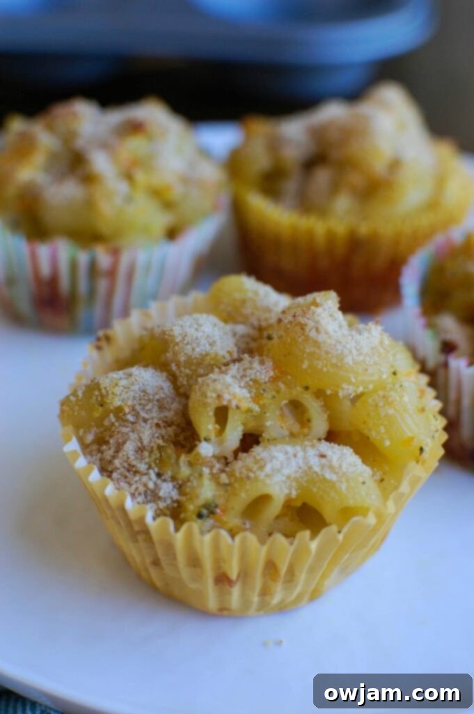 A serving of freshly baked Mac and Cheese Muffins on a plate, ready to be enjoyed.