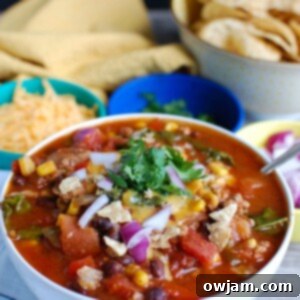Set-It-and-Forget-It Turkey Kale Chili 6 A bowl of Hearty Turkey Kale Chili topped with a swirl of sour cream, ready to eat.