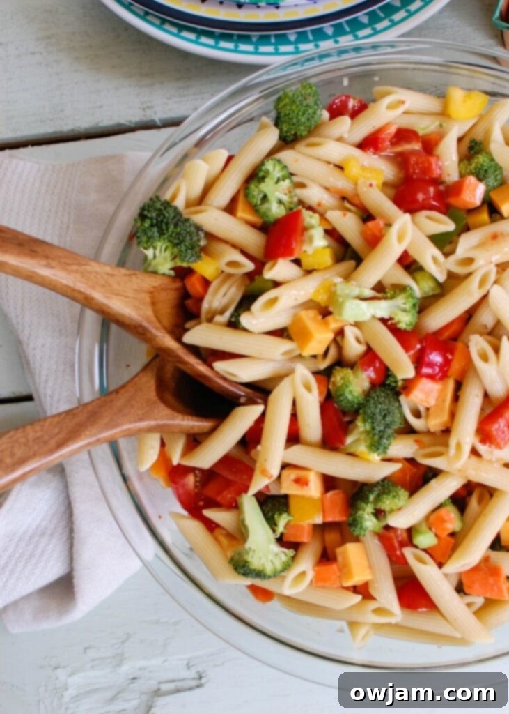 A bowl of fresh Classic Pasta Salad, featuring abundant garden-fresh vegetables, highlights the joy of simple summer meals.
