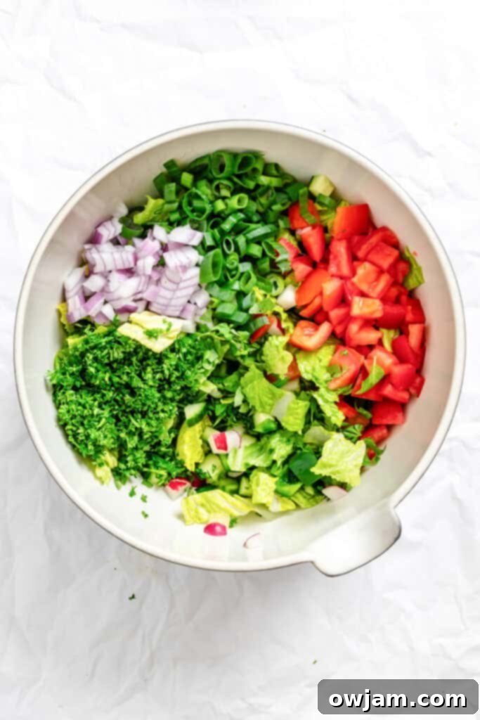 Chopped Fattoush Salad ingredients in a large mixing bowl
