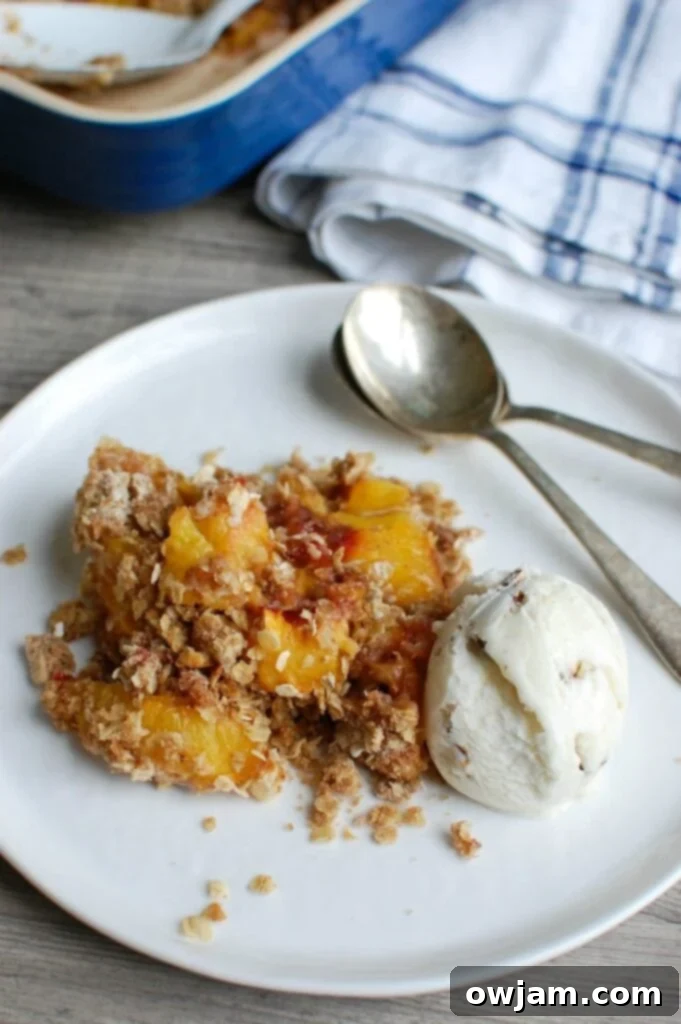 Peach Crisp is the best summer dessert. Fresh, warm peaches are topped with a crumbly topping and paired with ice cream. 