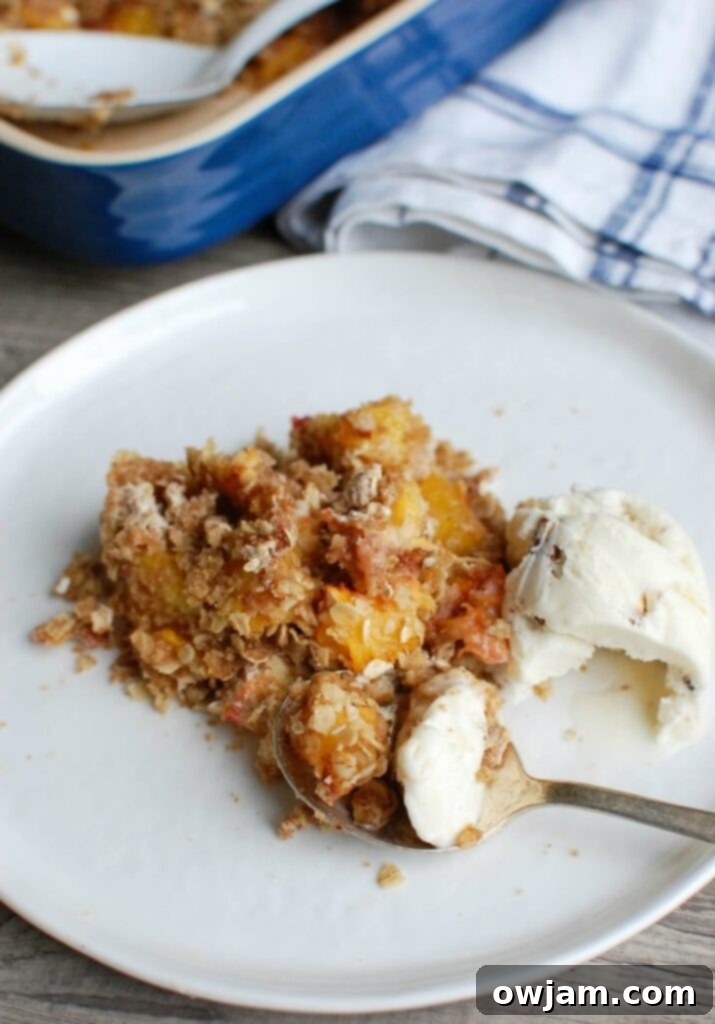 Peach Crisp is the best summer dessert. Fresh, warm peaches are topped with a crumbly topping and paired with ice cream. 