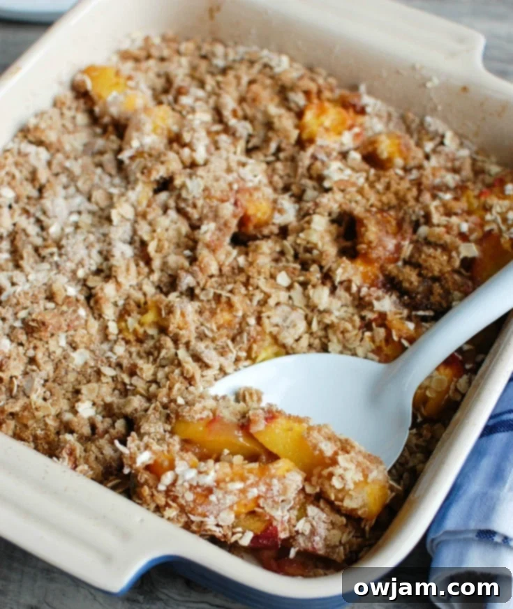 Peach Crisp is the best summer dessert. Fresh, warm peaches are topped with a crumbly topping and paired with ice cream. 