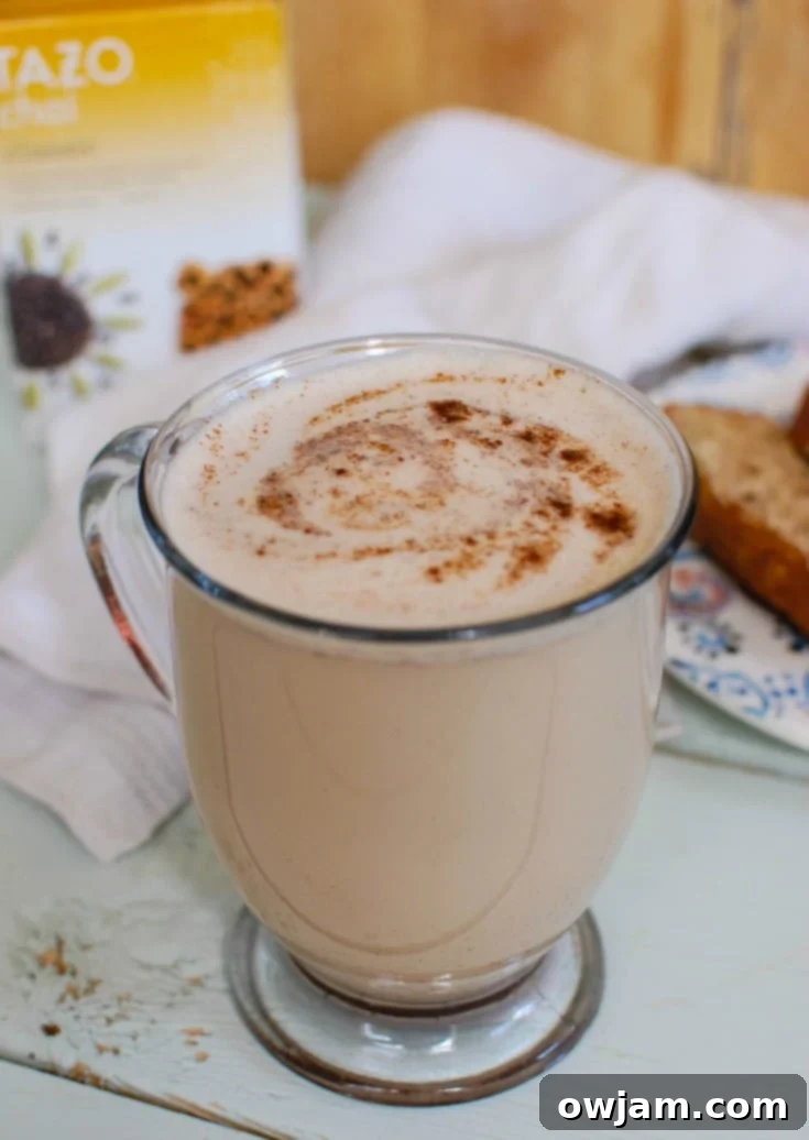 Cozy Spiced Chai Latte 2 A steaming cup of Homemade Chai Tea Latte, garnished with cinnamon.