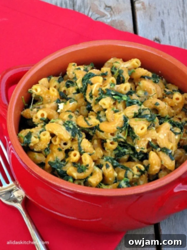 A bowl of Stovetop Spinach Mac & Cheese, cheesy and green.