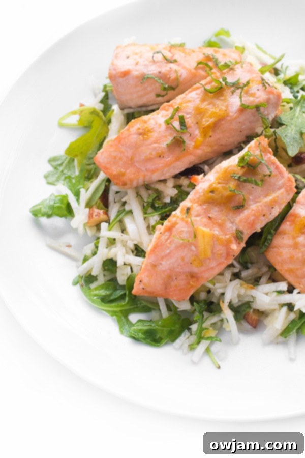 A plate of Roasted Brown Sugar Salmon with Orange Jicama Slaw.