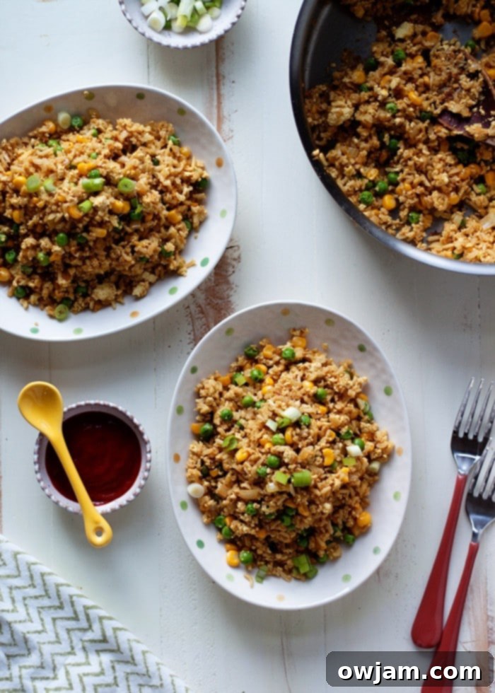 Scrambled Tofu Fried Rice in a pan, with colorful vegetables.