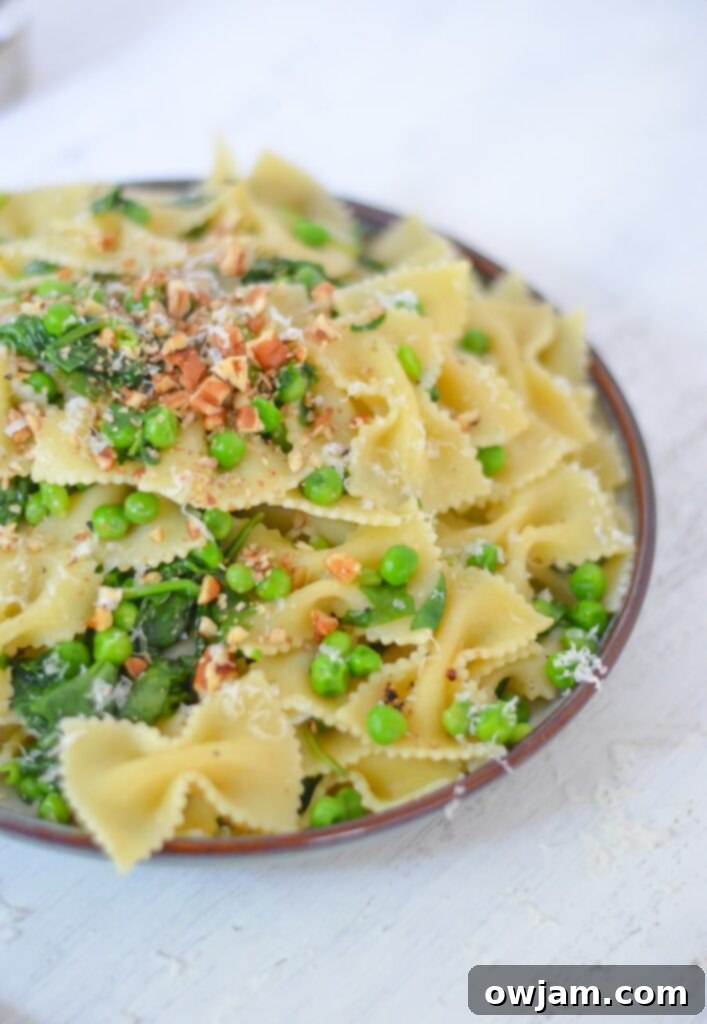 A bowl of Pea Pasta with spinach, ready for a quick dinner.
