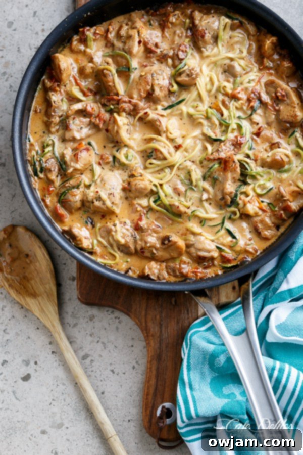 Creamy Sundried Tomato and Parmesan Chicken Zoodles in a skillet.