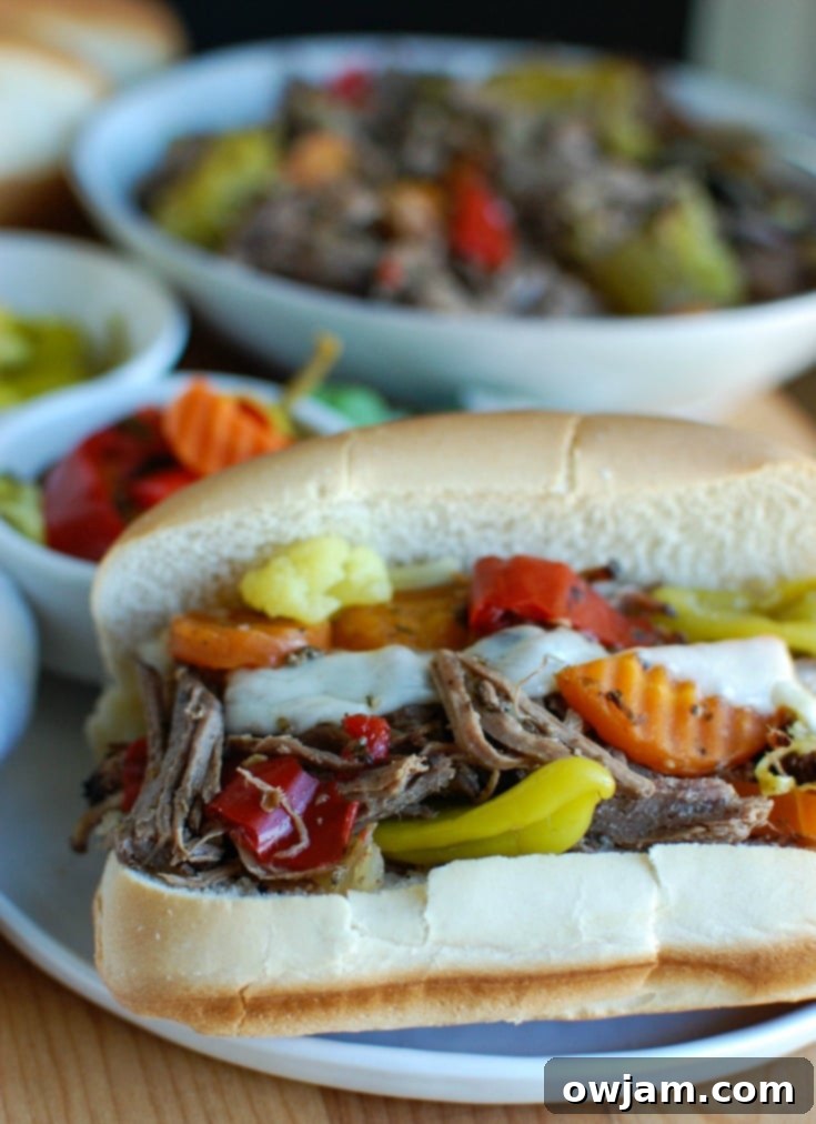 Ultimate Slow Cooker Italian Beef Sandwiches 4 Slow Cooker Italian Beef Sandwiches make a great game day food or weeknight dinner that easily cooks in your crockpot. Chuck roast is slowly cooked in Italian seasonings, beef broth and mixed with pepperoncini peppers and Giardiniera. Toast the beef in a hoagie bun with provolone cheese and extra pepperoncini and Giardiniera for the perfect sandwich.