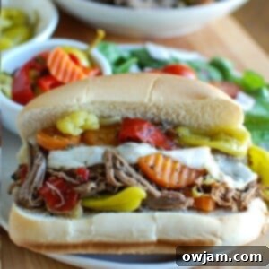 Ultimate Slow Cooker Italian Beef Sandwiches 5 Slow Cooker Italian Beef Sandwiches on a white plate and on a bun
